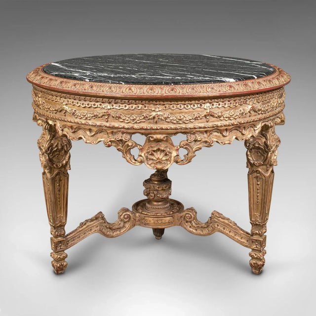 This is a grand vintage circular table. A Continental, giltwood and marble centrepiece table in Rococo revival taste,...
