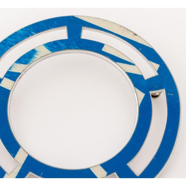 Boris Bally (American, b. 1961) Recycled Street Sign Circular Pierced Brooch, 2000, marked "Bally" and dated "Y2K" to...
