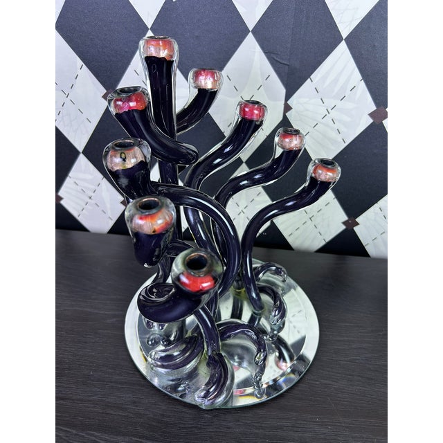 Sculptural handblown art glass Hanukkah menorah by Michael Hudson of Hudson Glass. The nine-light form is composed of...