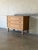 This refined chest features three spacious drawers set on carved turned legs. The top drawer opens to reveal green felt-...