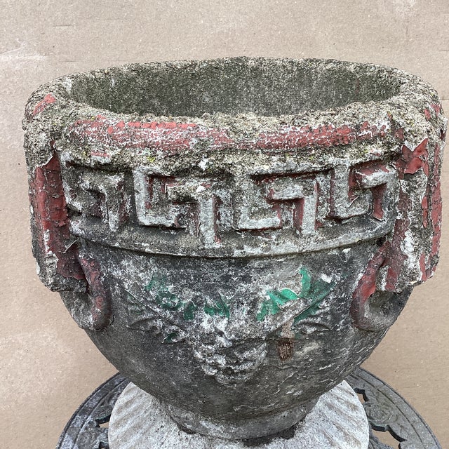 The product is an antique Greek key cast concrete garden planter/jardiniere adorned with grape clusters. This unique piece...