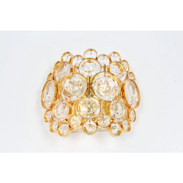 A stunning golden sconce, made by palwa, germany, circa 1960-1969. Crystal glasses on a gilt brass frame. Best of the...