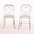 A charming set of four French garden chairs, circa 1950, crafted in wrought iron with graceful open scrollwork detailing...