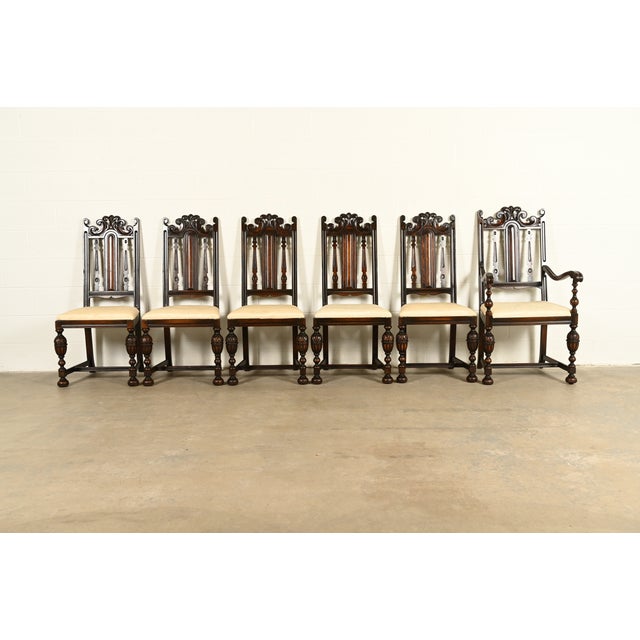 A beautiful set of six antique English Jacobean or Tudor style dining chairs By Berkey & Gay USA, Circa 1920s Carved...