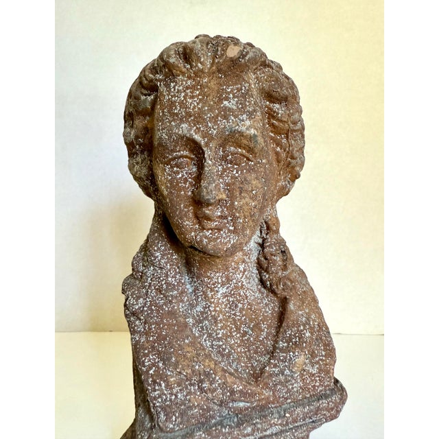 Here is a late 20th century neoclassical-style female bust sculpture with a weathered terracotta finish and textured cast...