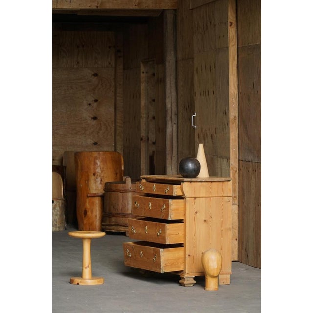 A charming Scandinavian chest of drawers crafted from solid pine in Denmark during the late 19th to early 20th century....