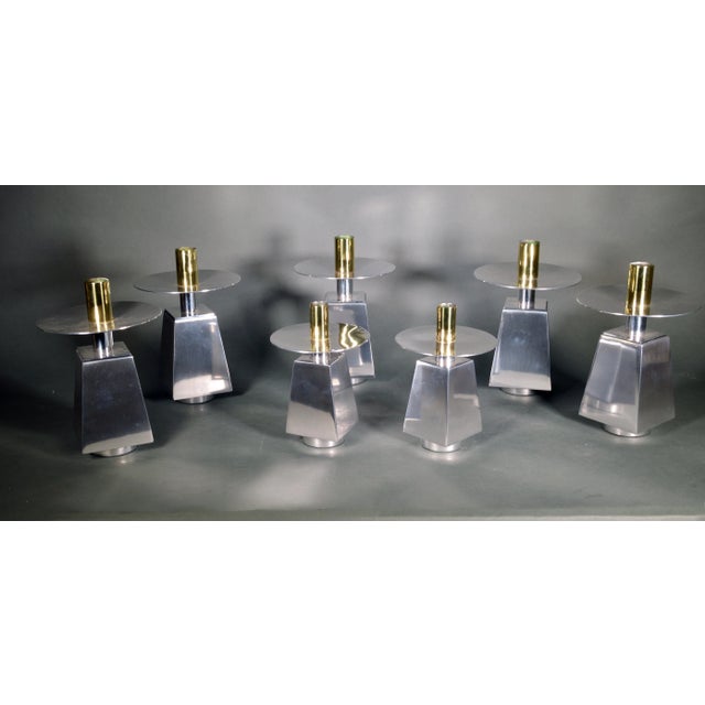 The Architecture of Light: A Set of Mid-Century Chrome and Brass Candlesticks, 1970s–80s This striking set of seven...