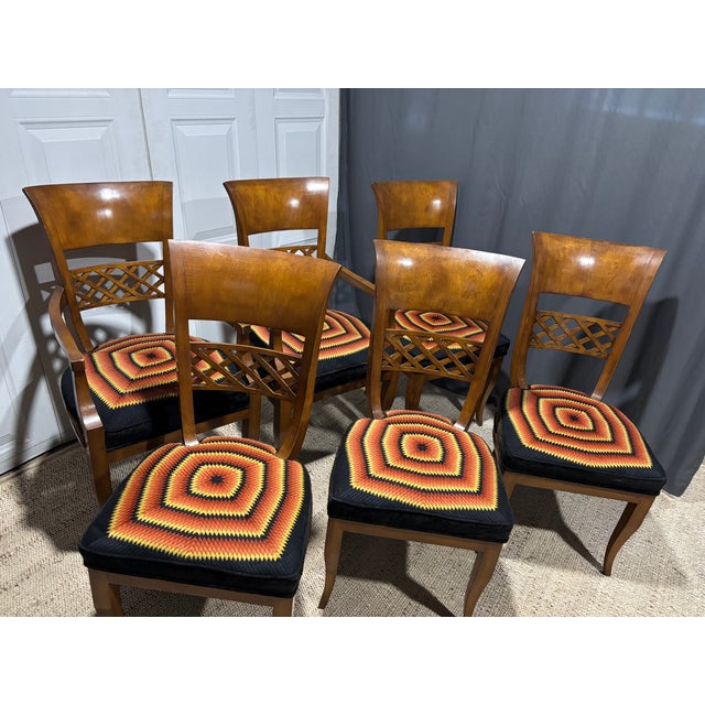 These chairs are a mid-20th century dining chair crafted in a traditional style with a curved back and lattice backrest...