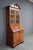 Elegant Council Craftsmen mahogany secretary bookcase featuring a classic broken pediment crown with center finial, richly...