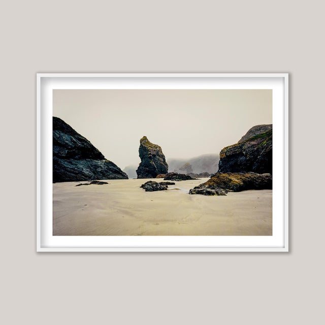 A mid-summer photograph of Kynance Cove, a breathtaking beach on The Lizard Peninsula in Cornwall, England. A soft, misty...