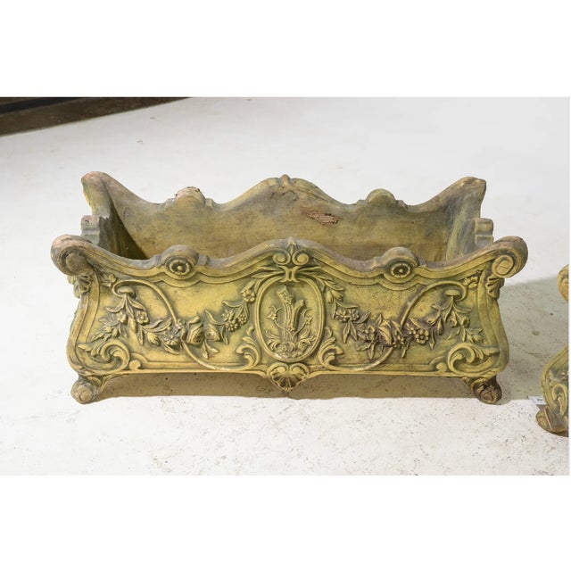 Elegant vintage cast stone planters with beautifully detailed French-inspired relief carvings and a naturally aged patina...