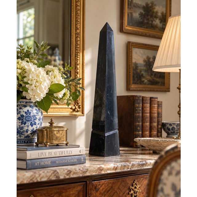 A beautifully proportioned black marble obelisk The sculptural silhouette and naturally dramatic stone movement give the...