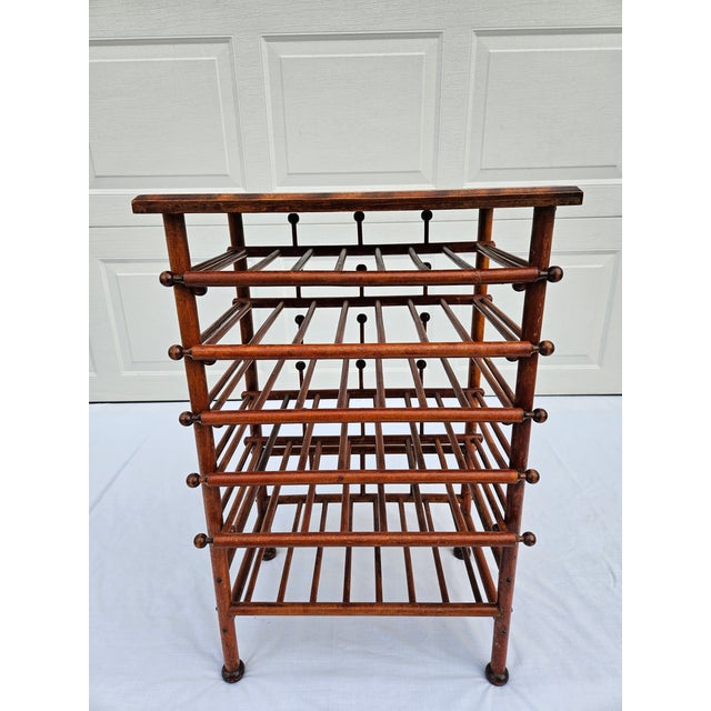This antique stick and ball sheet music stand or magazine rack is full of charm. The upper five shelves slide forward for...