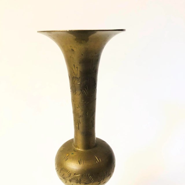 A vintage brass vase with a lovely etched floral design to the surface.