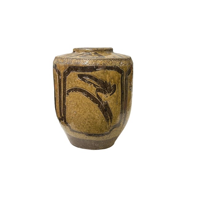 This ancient ceramic jar exudes a rustic charm, its weathered surface telling tales of centuries past. The vessel, crafted...