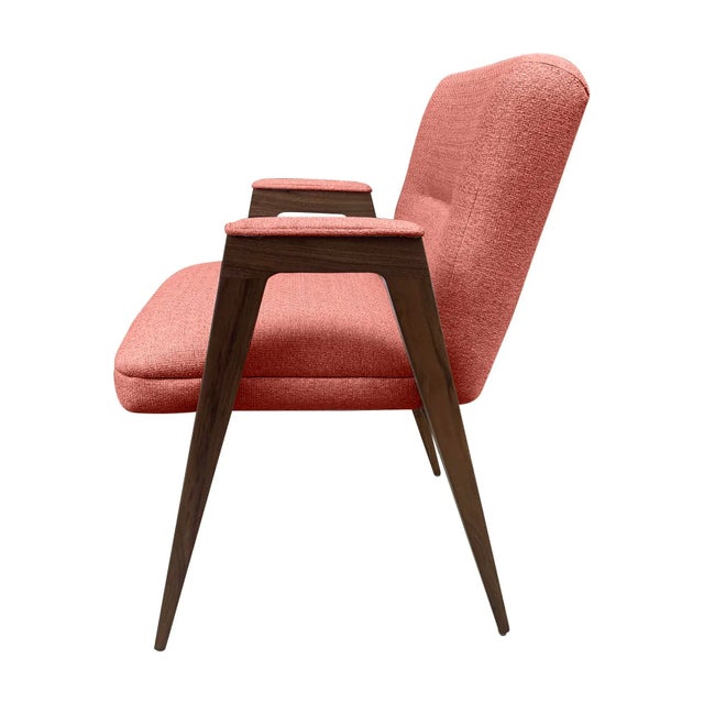 Modern mid century style dining chair. The chair frame is walnut and upholstered in a coral chenille. The chair has a fun...