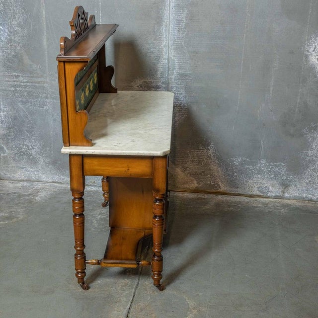 A very attractive late Victorian washstand with an unusual shaded walnut finish and beautiful blue tiles with green...