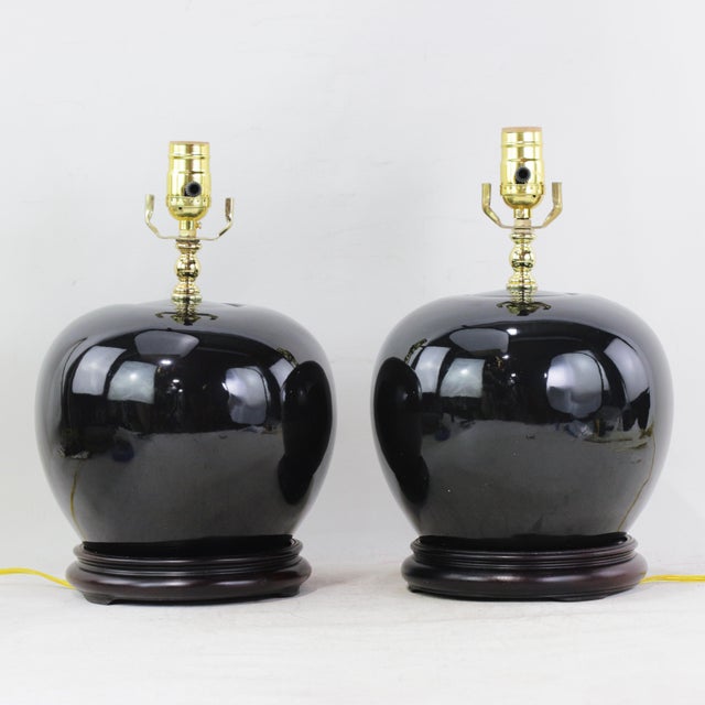 A Pair Early 20th Century Black Monochrome Porcelain Watermelon Jar Table Lamps on Carved Wood Bases For Sale - Image 15 of 15