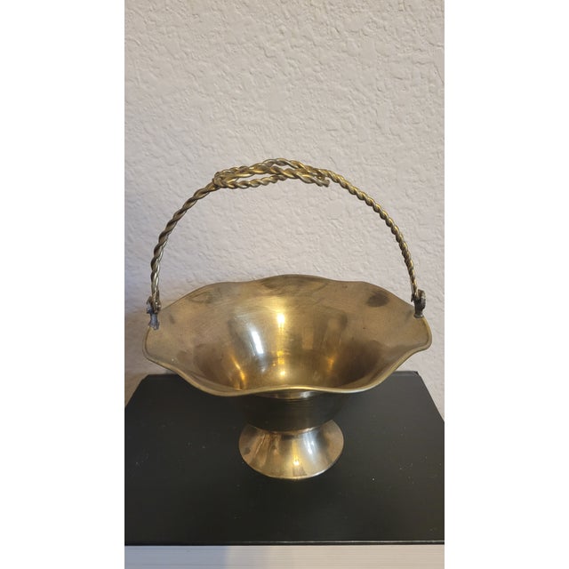 Cute vintage small basket with swivel twisted rope handle and scalloped edges. With handle in upright position measures 6"