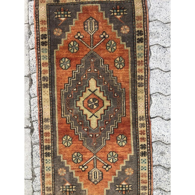 This is a vintage Turkish Oushak rug from the 1960s. The piece was hand-knotted.