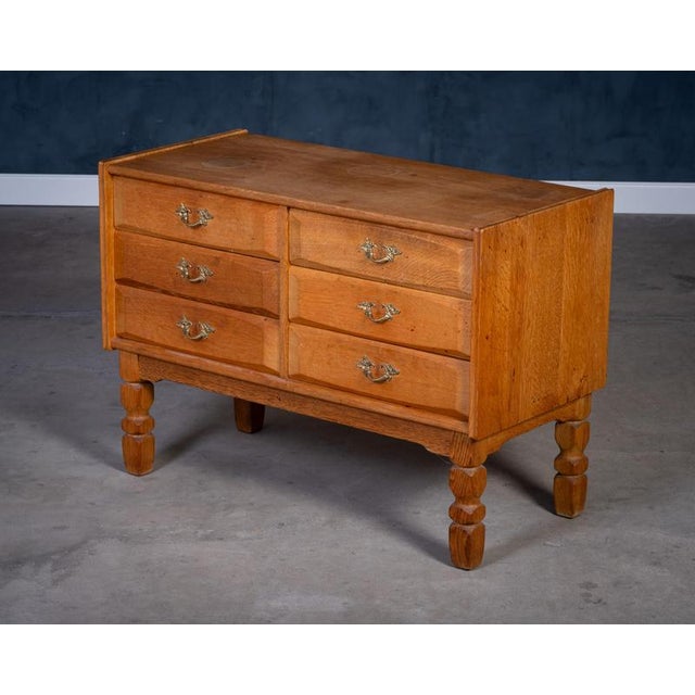 Solid oak chest of drawers, in the style of Henning Kjærnulf, 1970s. A beautiful example of Danish brutalist design with...