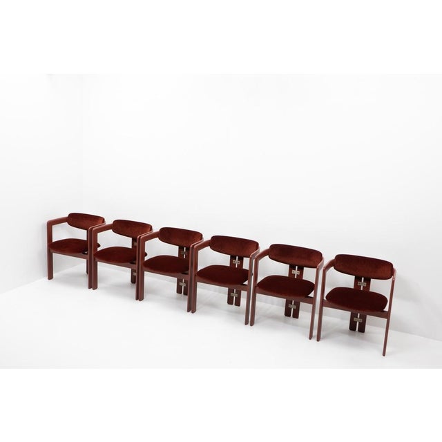 Set of six “Pamplona” dining chairs by Augusto Savini for Pozzi, featuring a painted wooden frame with velours upholstery....