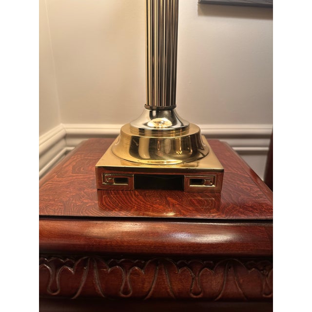 This vintage 3 arm candlestick Baldwin Brass style bouillotte lamp with black and gold shade is in remarkable condition. A...