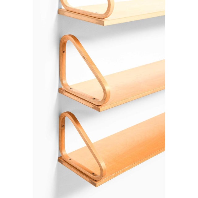 These rare wall shelves, designed by alvar aalto and produced by artek in finland, exemplify the enduring appeal of...