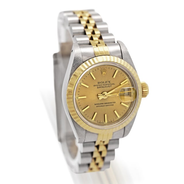 Vintage Rolex Datejust Ref. 69173 features a 26mm stainless steel case, a fluted 18K yellow gold bezel, and a matching...