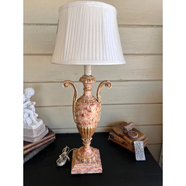 striking Italian giltwood table lamp. Masterfully crafted in Italy, the lamp base is designed in the classic form of an...