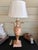 striking Italian giltwood table lamp. Masterfully crafted in Italy, the lamp base is designed in the classic form of an...