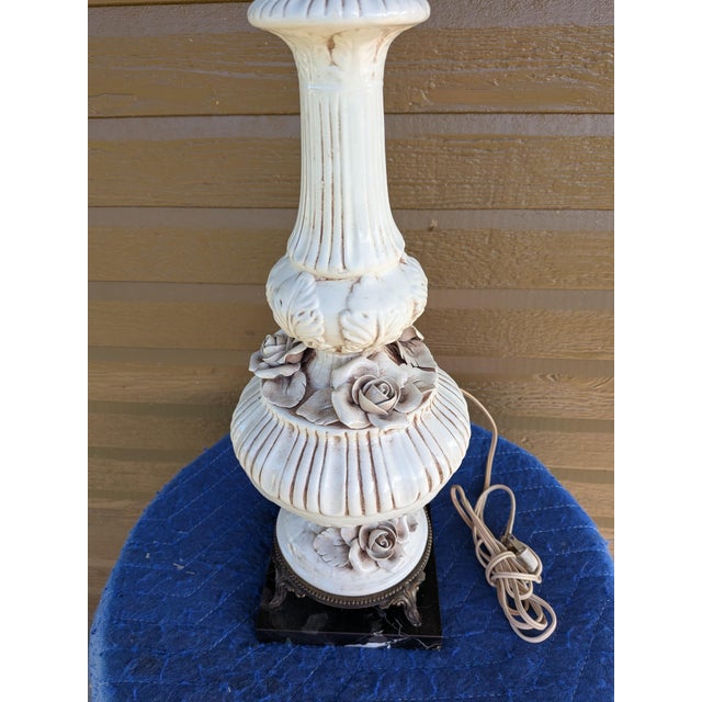 Phil Mar vintage lamp with shade features ornate rose floral detailing. It has a brass and ceramic base. Minor...