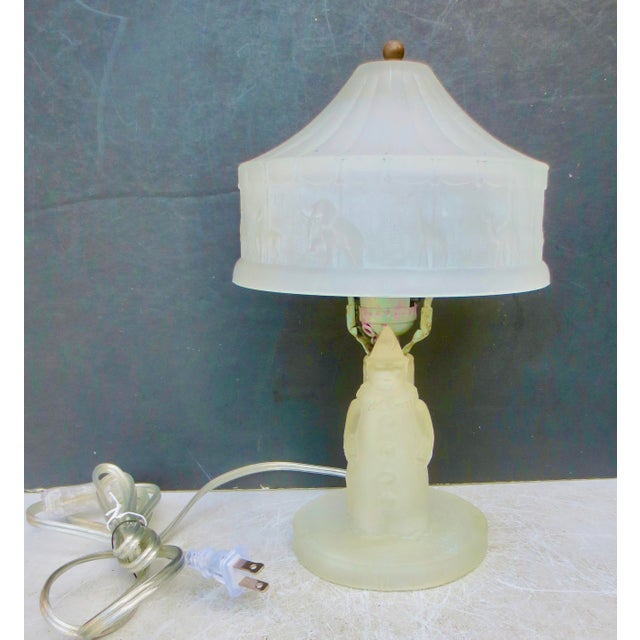 Frosted glass table lamp for kids. A clown stands in front with the big-top shade, bordered by a parade of animals:...
