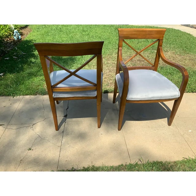 Mid-Century Modern pair of accent chairs. The chairs are made of walnut with a satin finish. We upholstered the chairs for...