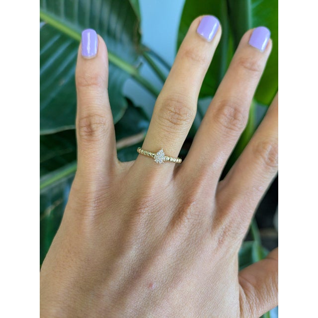 Eight round earth-mined diamonds sparkle across this solid 14K yellow gold band, totalling 0.09 carats. A clean, classic...