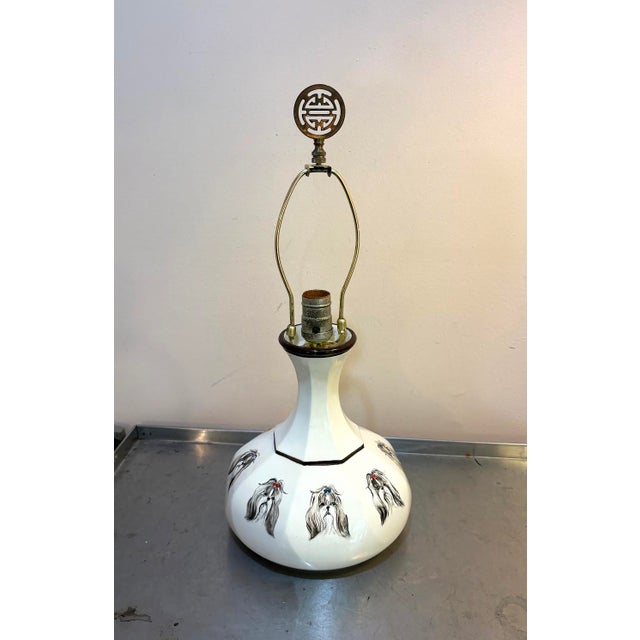 1950s-60s white ceramic painted Shih Tzu table lamp. Excellent condition. Measurements 20.5" tall including harp & finial...