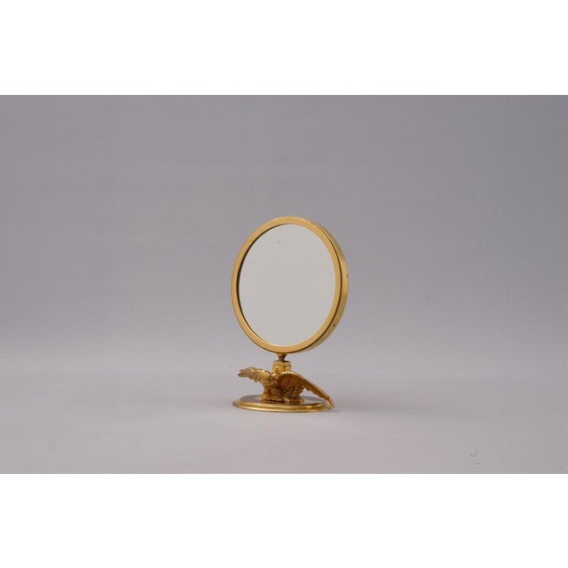Very rare table mirror by Hermès Paris. An eagle sits on a pedestal with its wings spread wide, reflecting the beauty of...