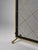 An elegant vintage fireplace screen combining refined geometric detailing with a striking contrast of black metal and warm...