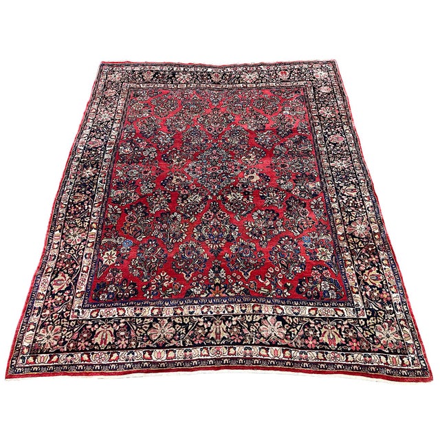 A fabulous antique Sarouk rugt, woven circa 1920. The rug features an allover design of flower bouquets on a terracotta...