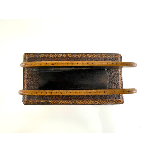 A richly detailed antique wooden letter holder featuring hand-burned pyrography decoration with floral and landscape...