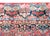 This antique Persian Sarouk rug, dating to the 1930s, features a classic all-over floral design on a rich red field. The...