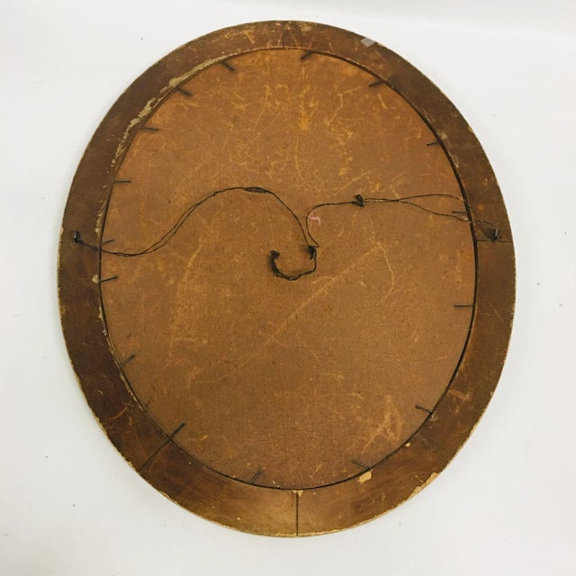 Antique oval gilt wood picture frame with applied decorations