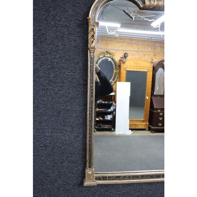 Elegant French-style wall mirror featuring a softly arched silhouette and decorative giltwood frame. The design is...