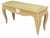 Vintage rattan console table with a sculptural silhouette, curved legs, woven construction, and a decorative circular...