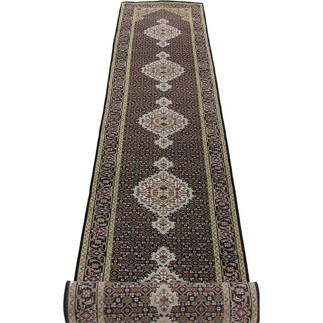 Traditional Handwoven Persian Tabriz Style Runner Rug featuring a Fish Design in a black-colored field enclosed in the...