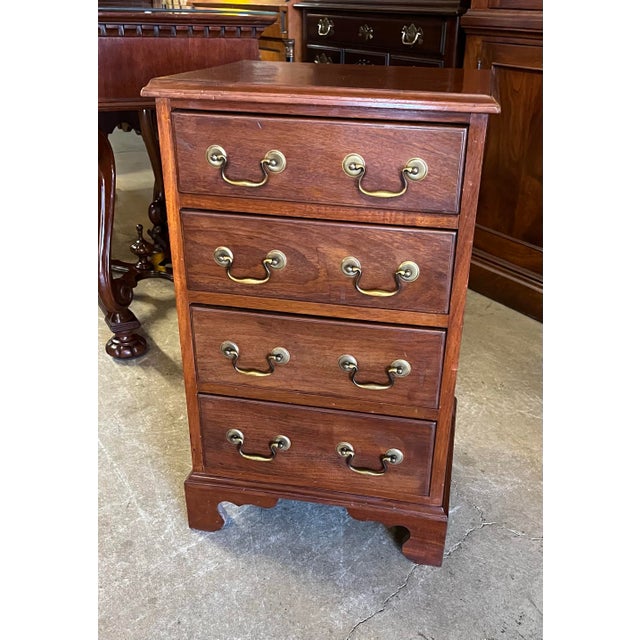 Interesting little antique four drawer Chippendale style bedside chest in mahogany. Beautiful wood grain on the top and...