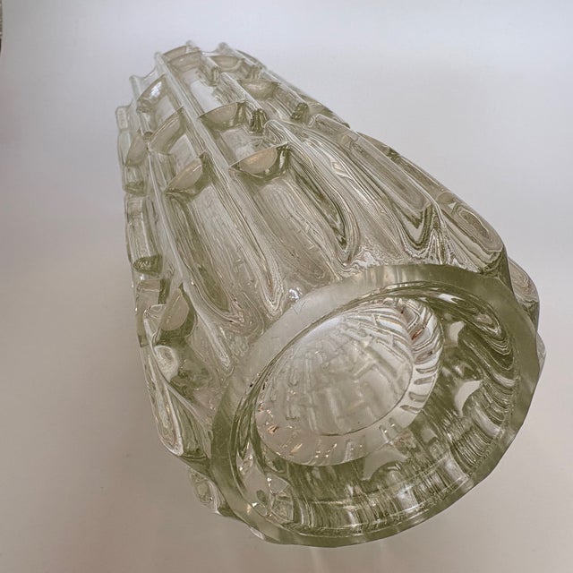 An iconic and highly sculptural pressed glass vase from the mid-century era, internationally known under the design names...