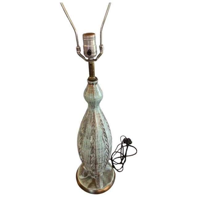 A premier example of Mid-Century Modern "Atomic" era California art pottery. This large-scale table lamp features a...