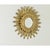 Dramatic feathered carvings of giltwood animate this antique Italian starburst mirror, the rays stretching upward and...
