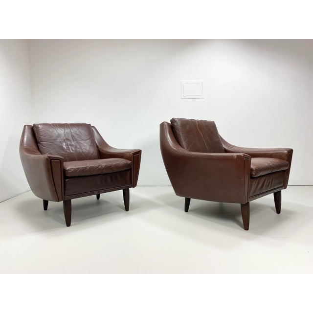 1960’s Danish Leather Lounge Chairs. Vintage Leather. Stained wood legs. Sculptural form.